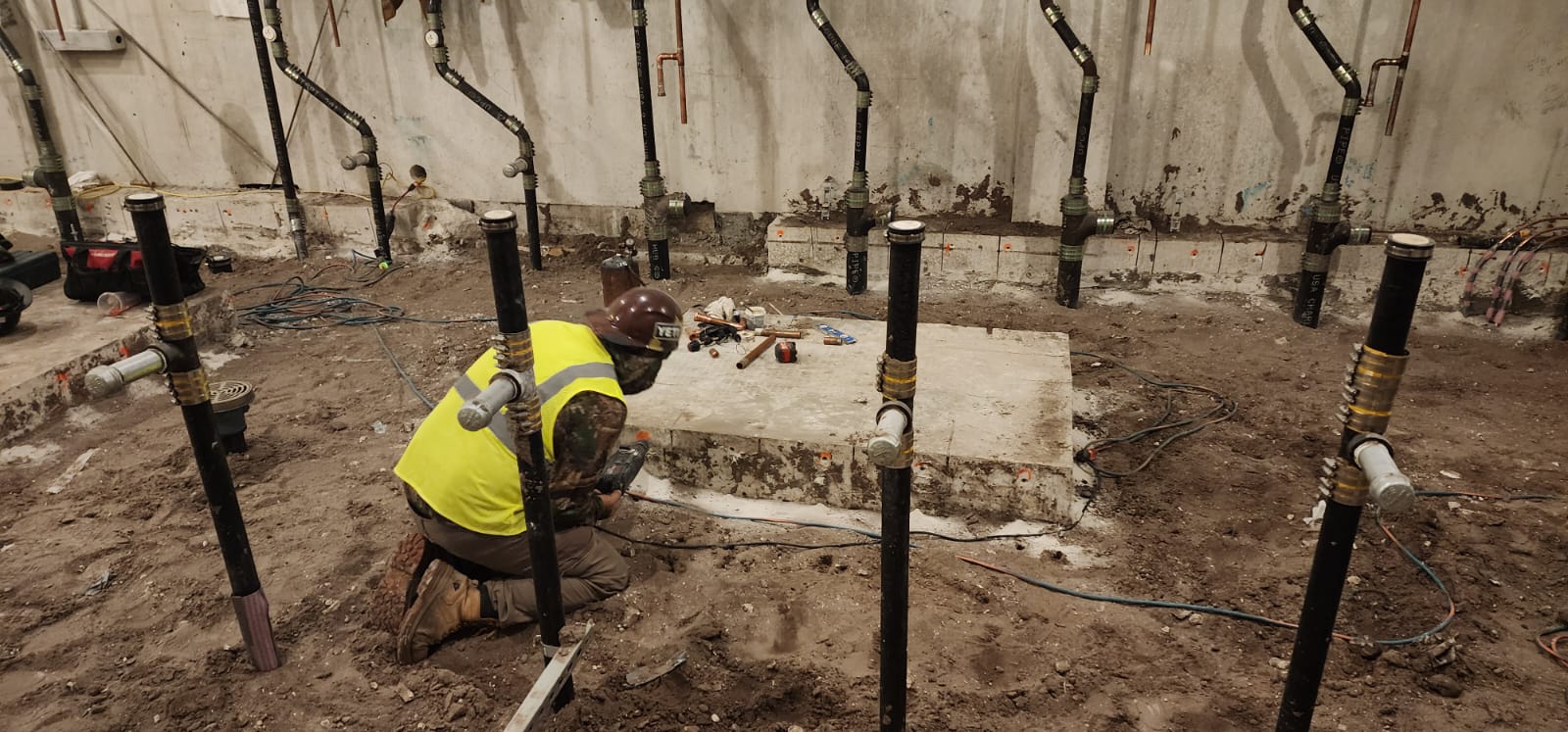 Residential plumbing rough-in showing supply and drain pipes in framed wall